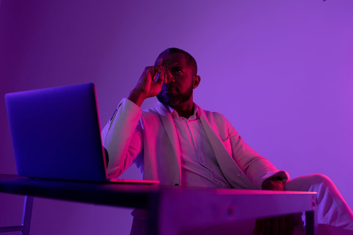 Photo of pensive man in white suit thinking about new web security project in night office near computer